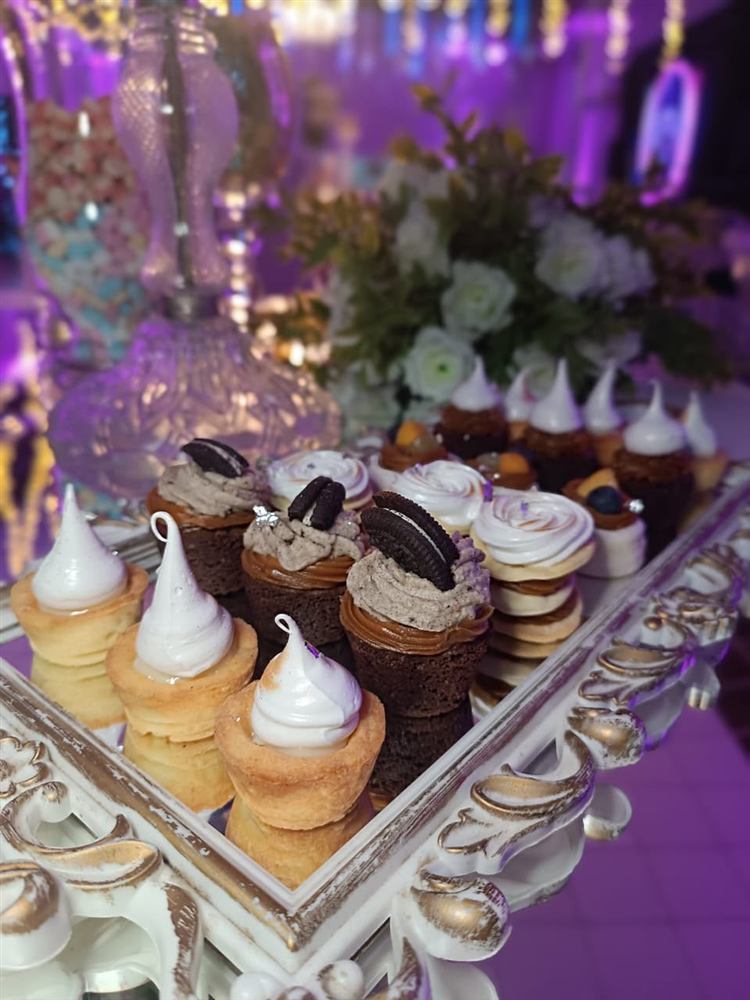 Mesa dulce con mini postres, cupcakes de oreo y suspiros de merengue